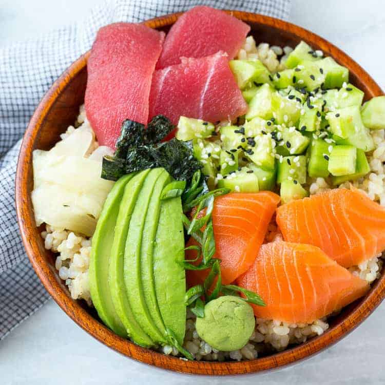 sushi rice in wooden bowl with veggies 