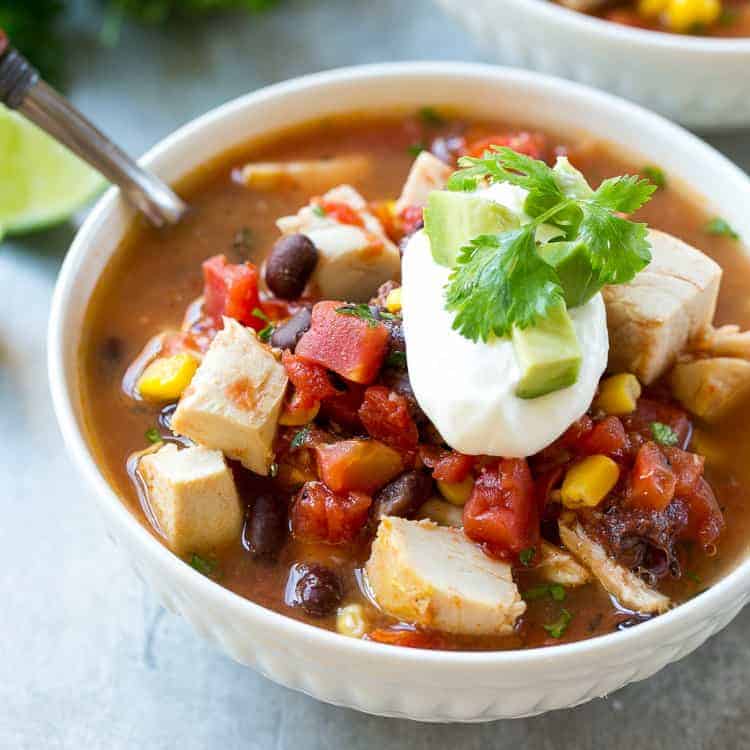 side shot of a white bowl of chicken mexican soup