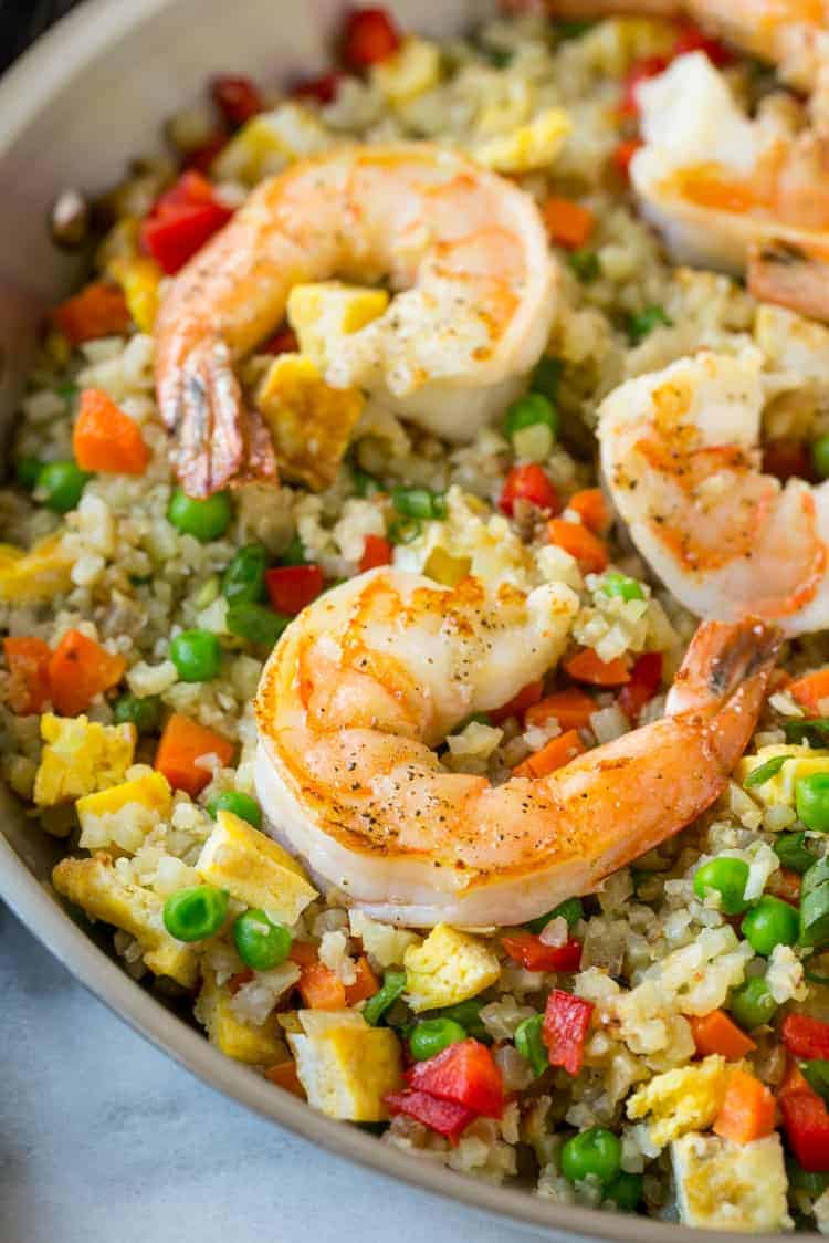 shrimp cauliflower fried rice in plate with green onions