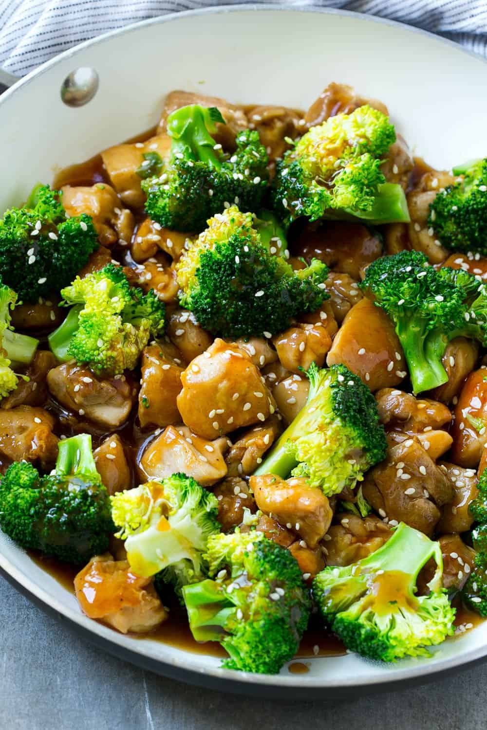 chicken and broccoli in pan with sesame seeds 