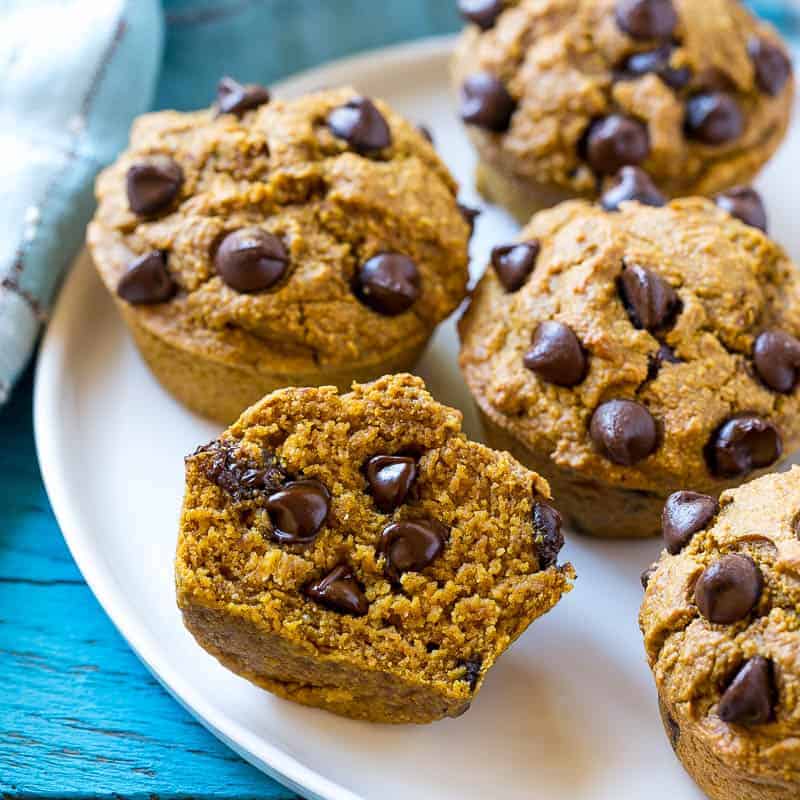 side shot of sliced Pumpkin Muffin on a white plate 