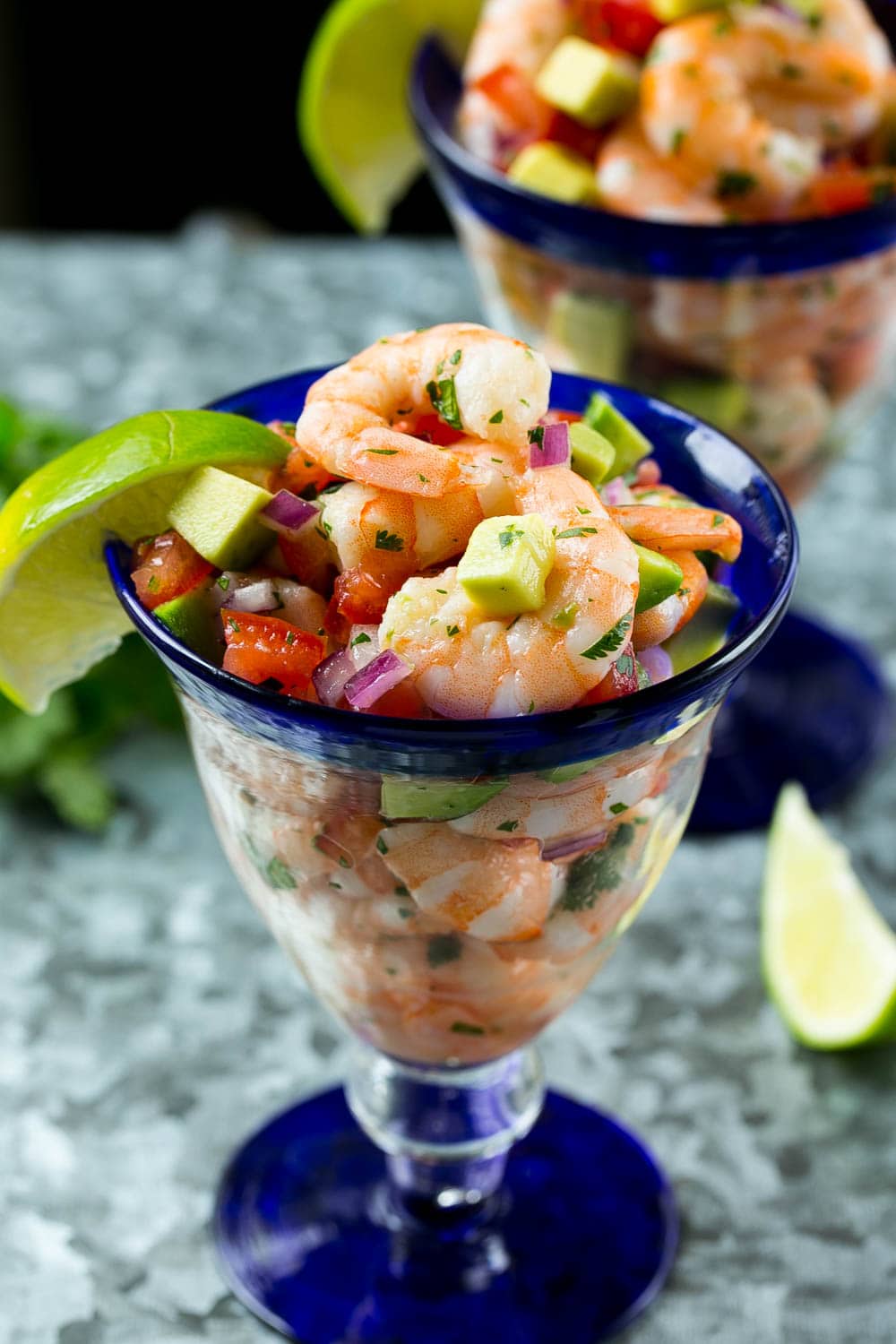 easy shrimp cocktail served in glasses with lime and cilantro 