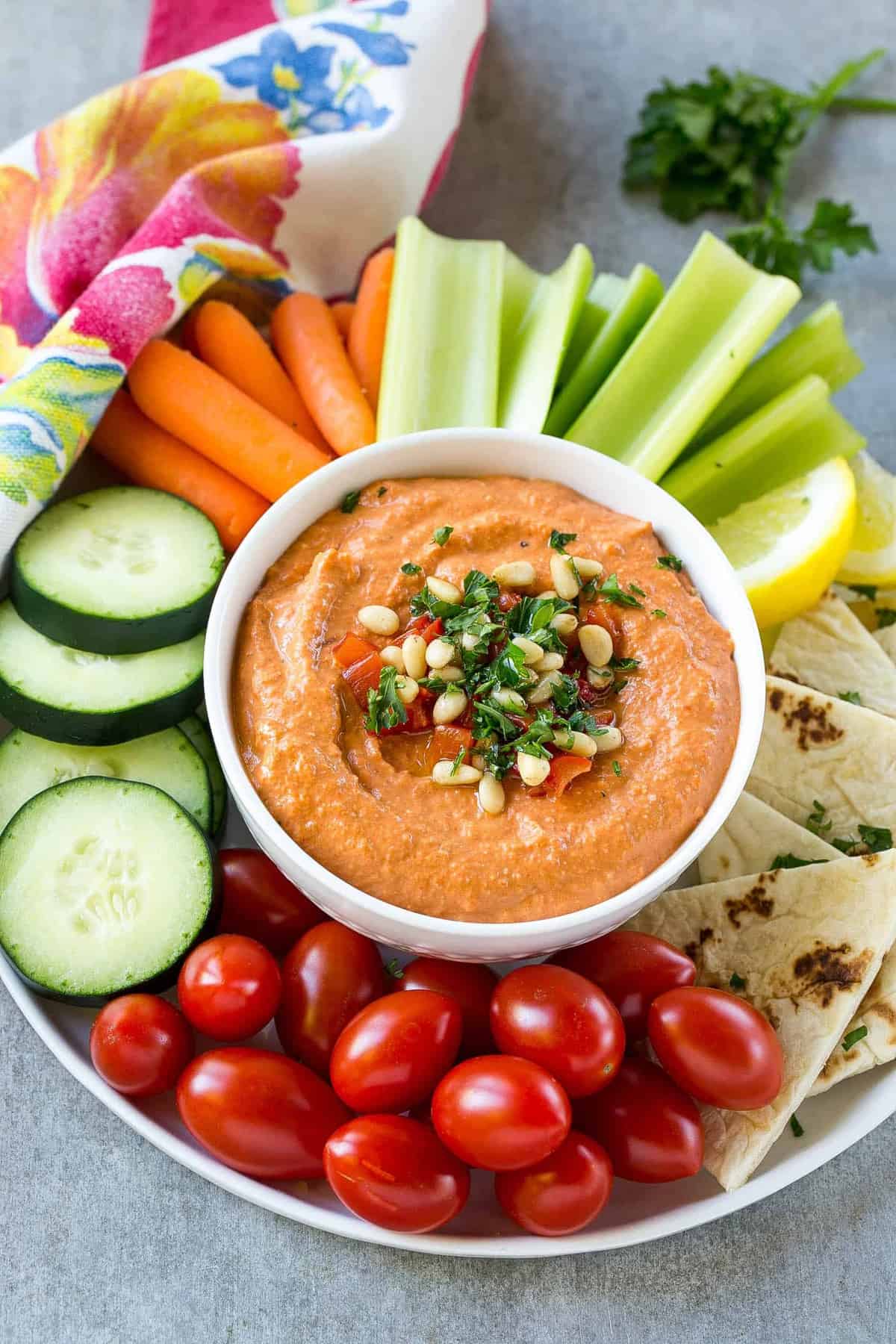  veggies on a platter with red pepper hummus