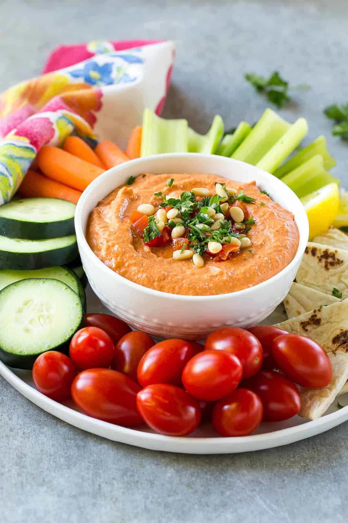 red pepper hummus served as an appetizer on a platter