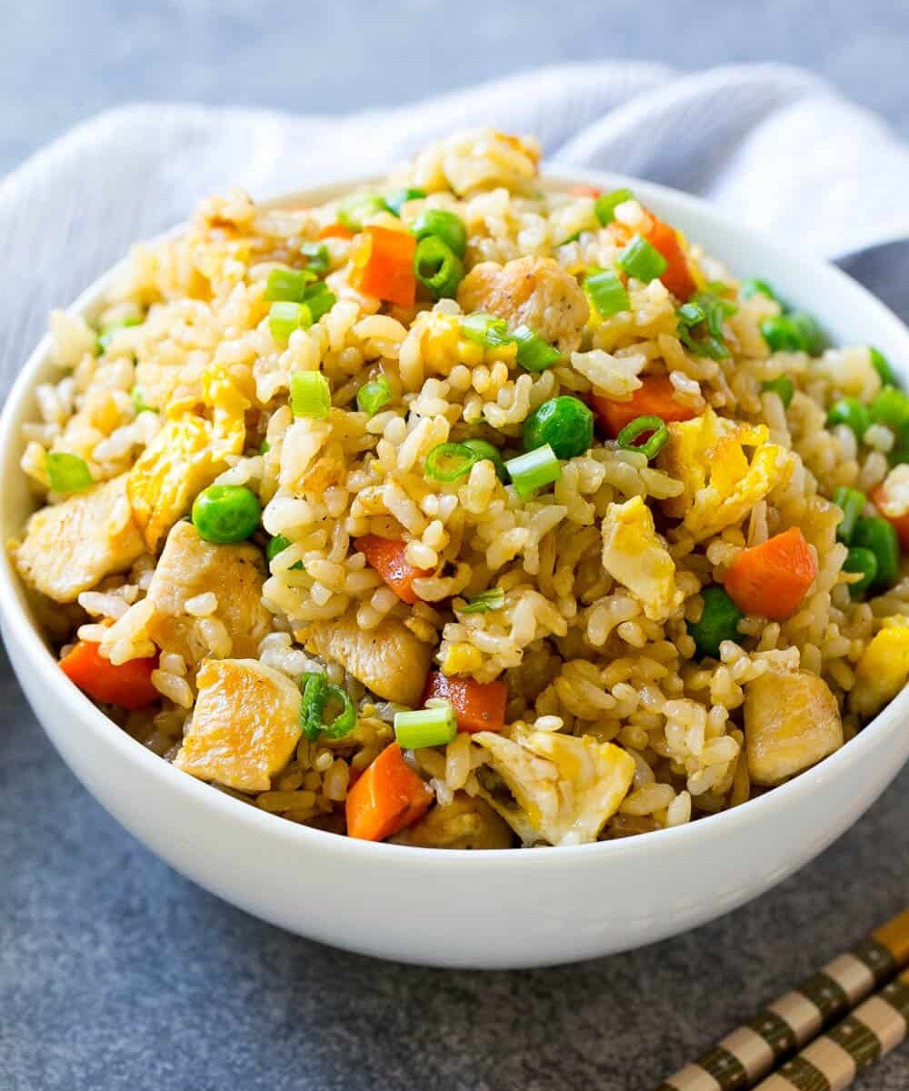 fried rice recipe with chicken in a round white bowl.