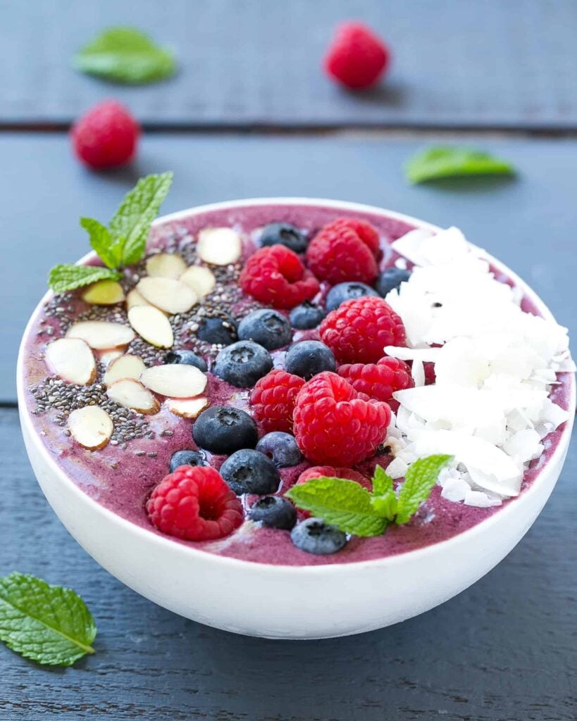 side shot of a smoothie bowl topped with berries 