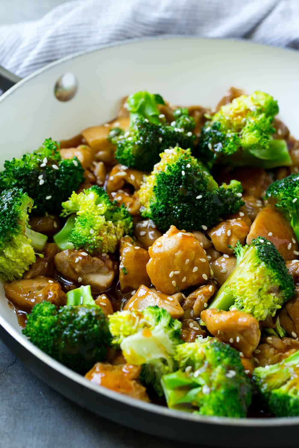 broccoli and chicken in bowl with sauce and sesame seeds