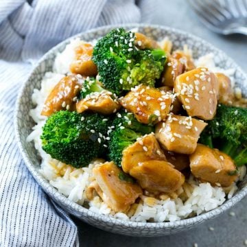 chicken and broccoli stir fry in bowl with rice and sesame seeds