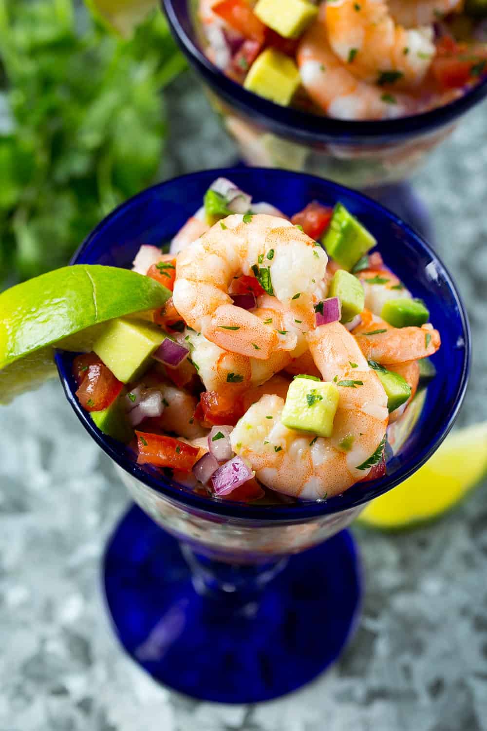 Mexican shrimp cocktail recipe in glass with lime and cilantro 