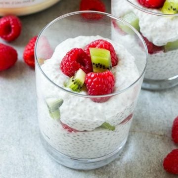 Coconut Chia Pudding with raspberries and kiwi in glass