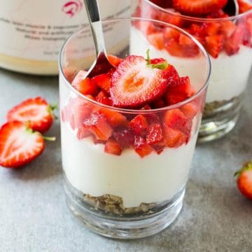 close up cheesecake in cup with strawberry topping