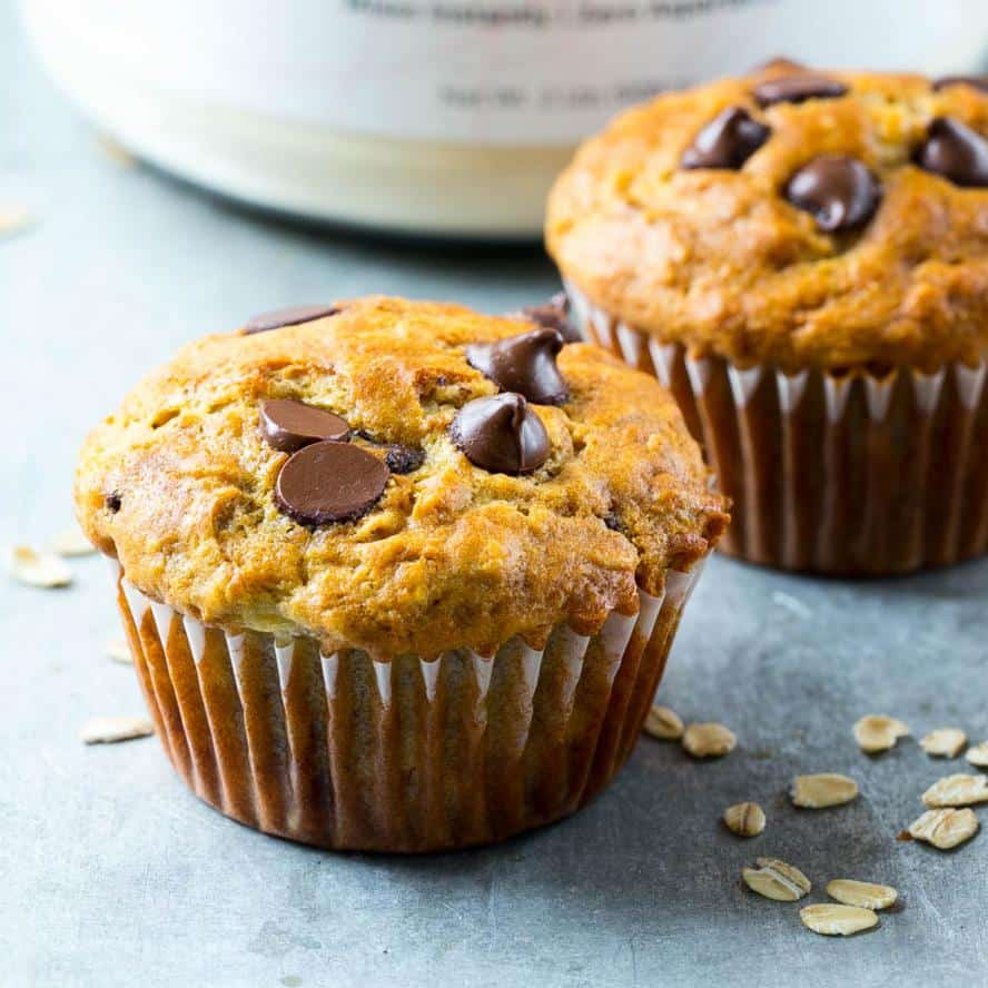 two banana oatmeal chocolate chip muffins on grey surface
