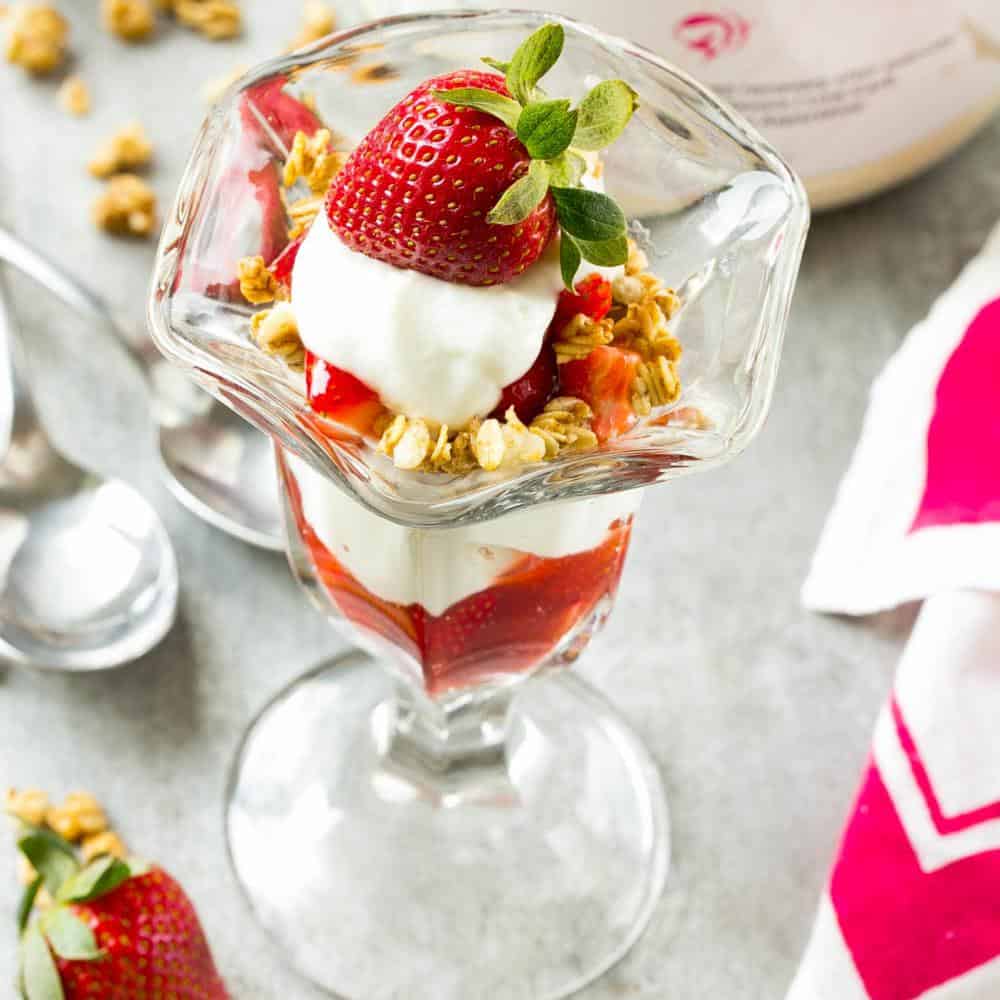 top view of a jar with strawberry Parfait with yogurt and fresh strawberries