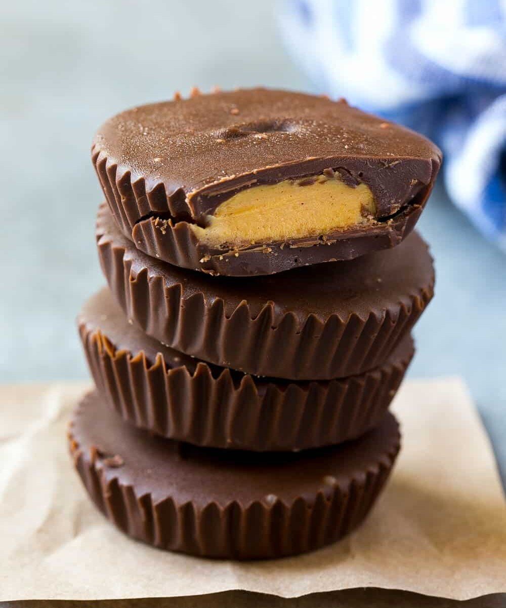 peanut butter cups stacked over each other on a parchment paper.