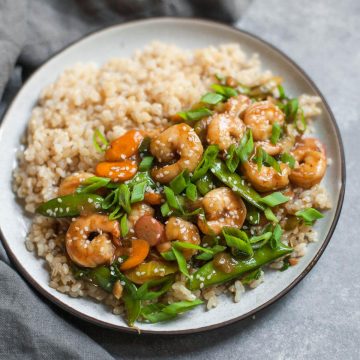 sesame shrimp stir fry in a bowl with rice