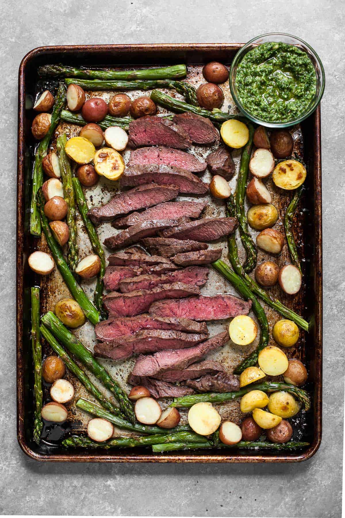 sheet pan with steak, pesto, asparagus, and potatoes