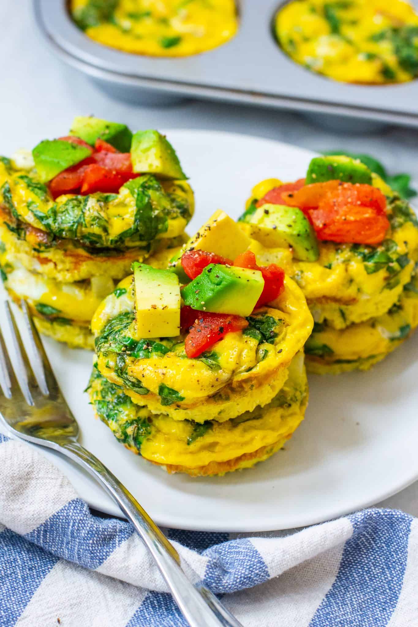 egg muffins topped with tomatoes and avocados