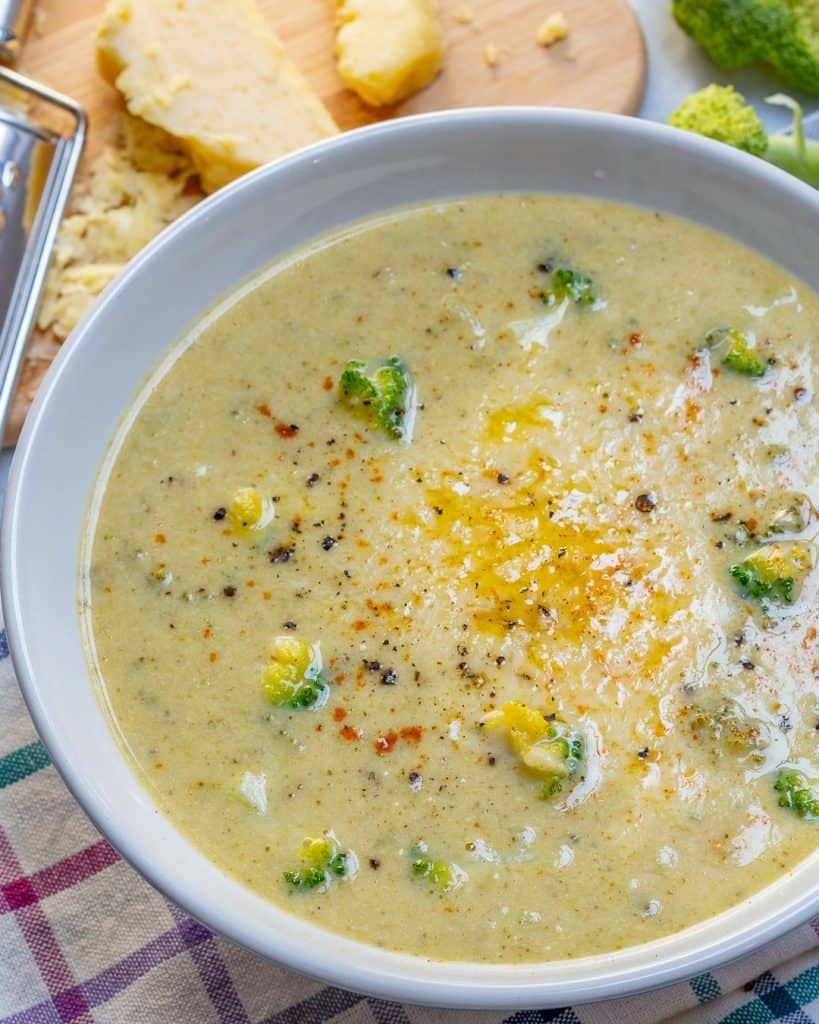 close up of Broccoli Cheddar Soup in a round white bowl 