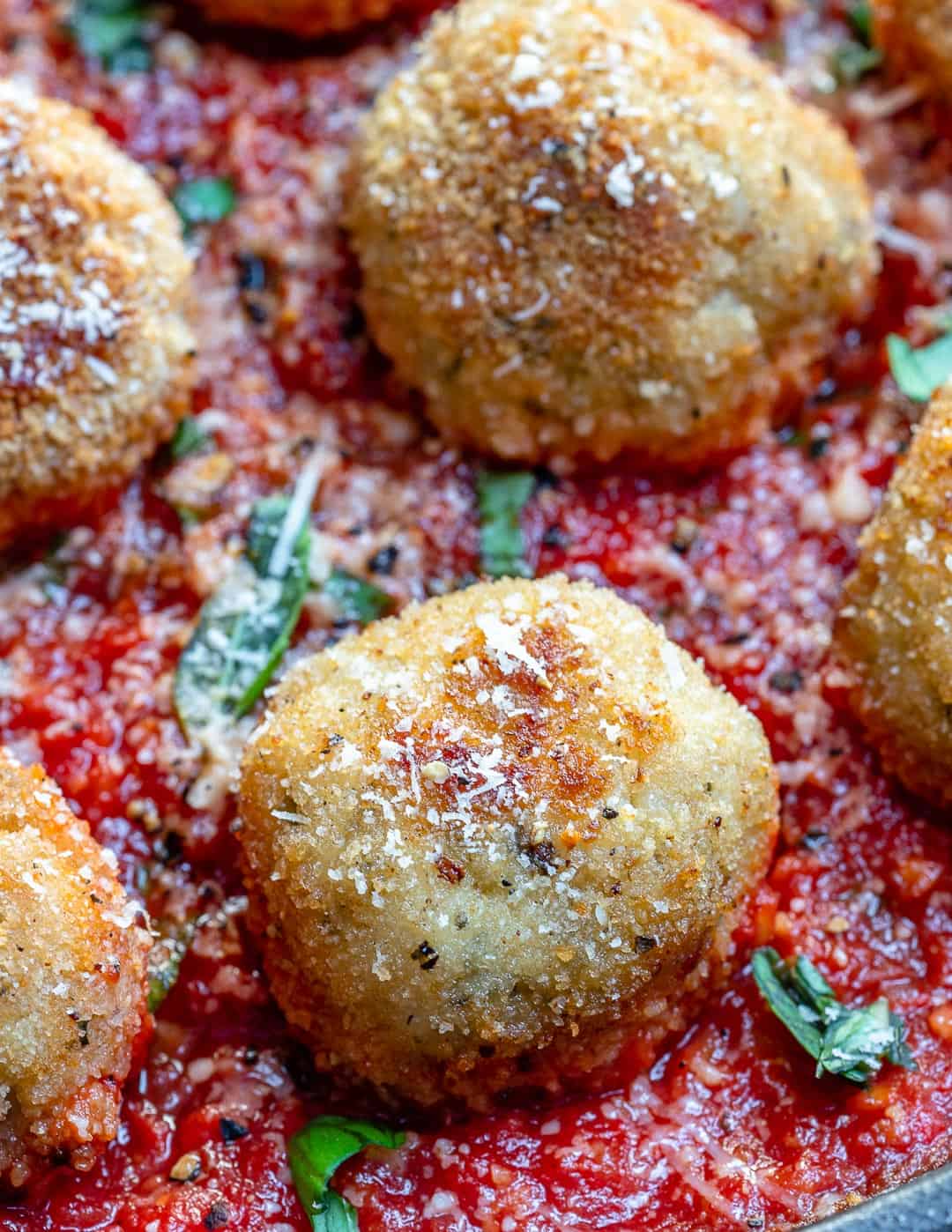 close view of chicken parmesan meatball in tomato sauce