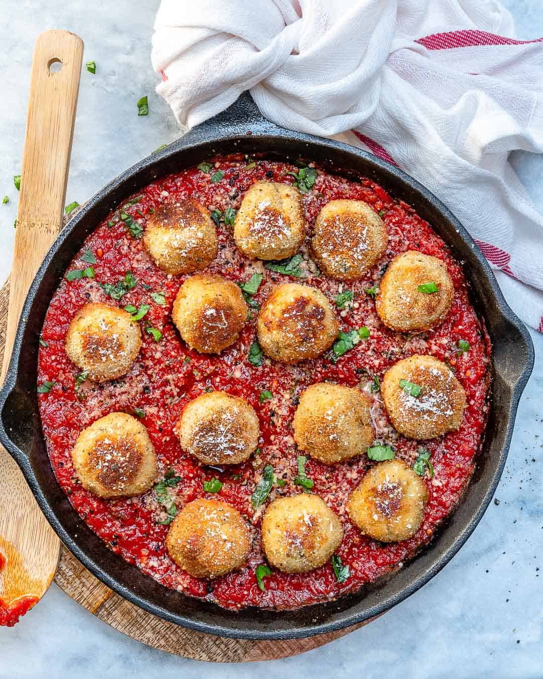 top view of chicken parmesan meatballs in tomato sauce in skillet