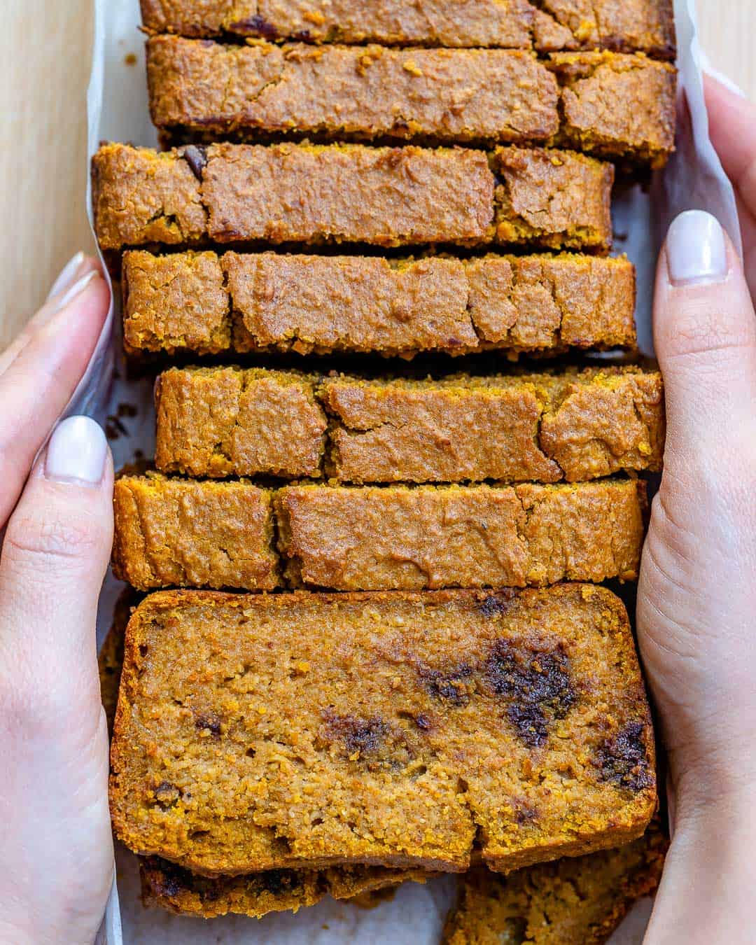 hand holding slices of pumpkin bread 