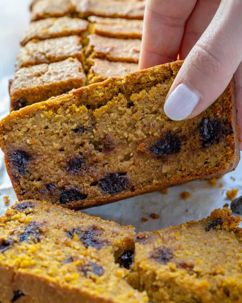 hand grabbing a slice of Pumpkin Bread