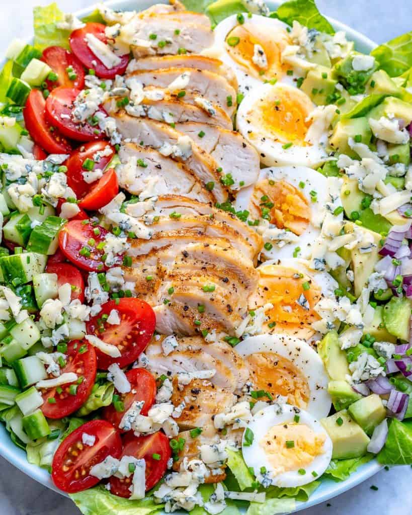 close up view of Cobb salad recipe with sliced grilled chicken and boiled eggs 