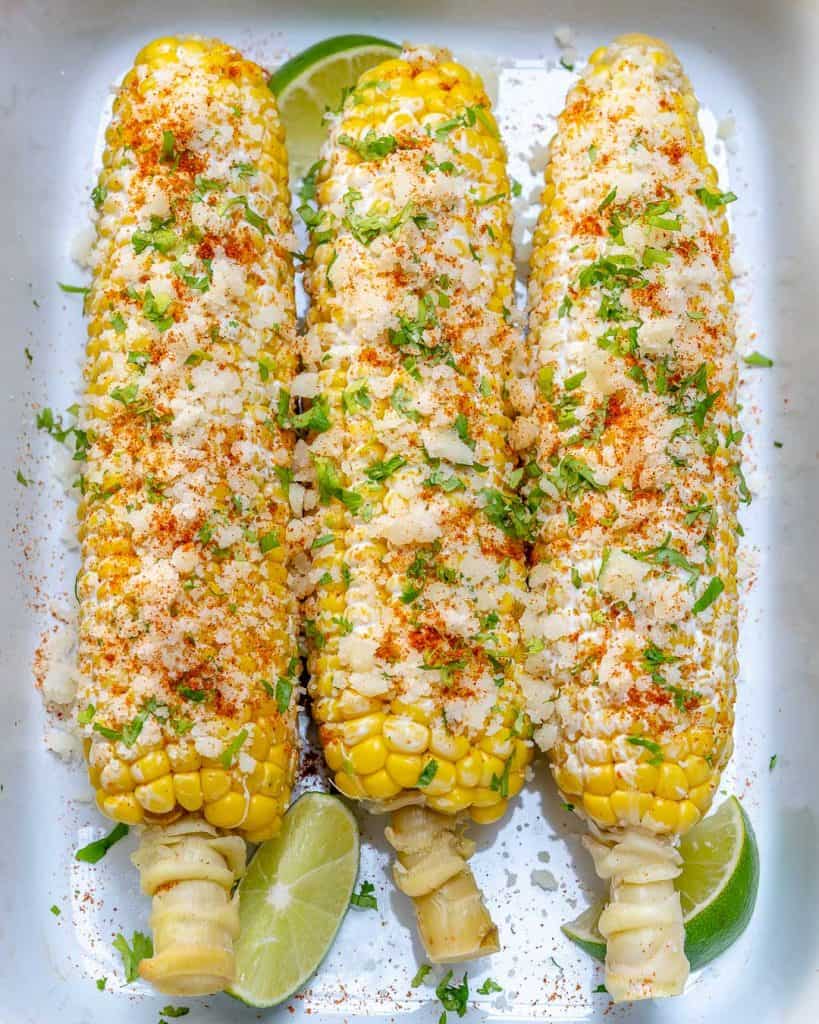 top view of 3 corn on the cob on a white plate 