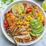 top view of grilled chicken Mexican bowl with sliced avocado corn and quinoa