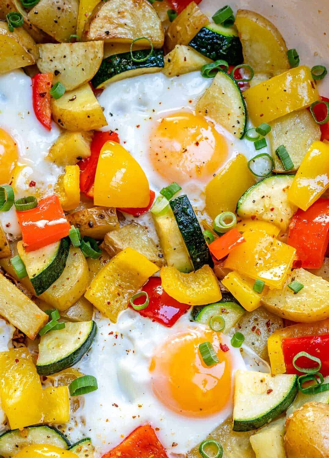 cooked eggs and veggies in a skillet.