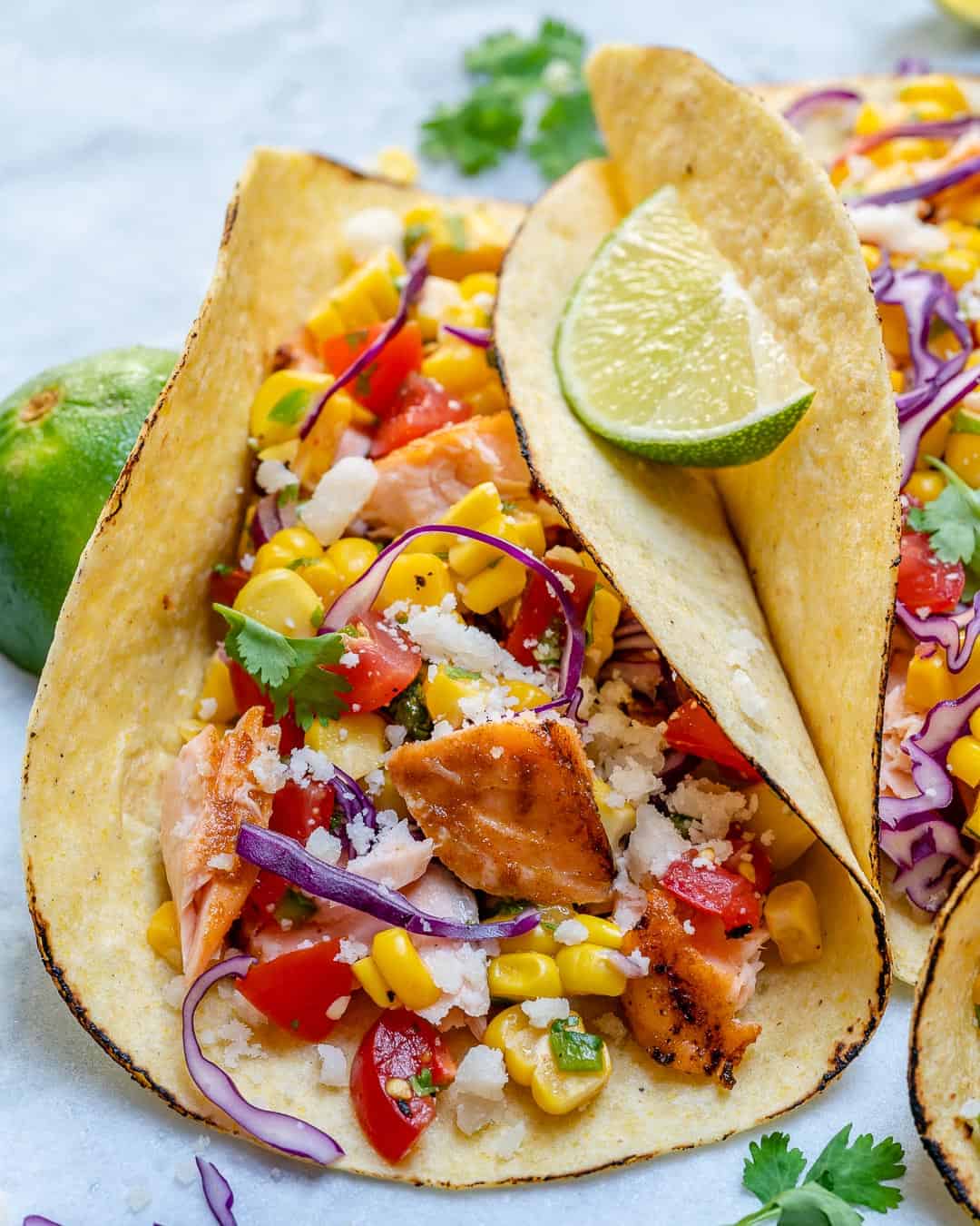 close up image of the salmon taco with slice of lime