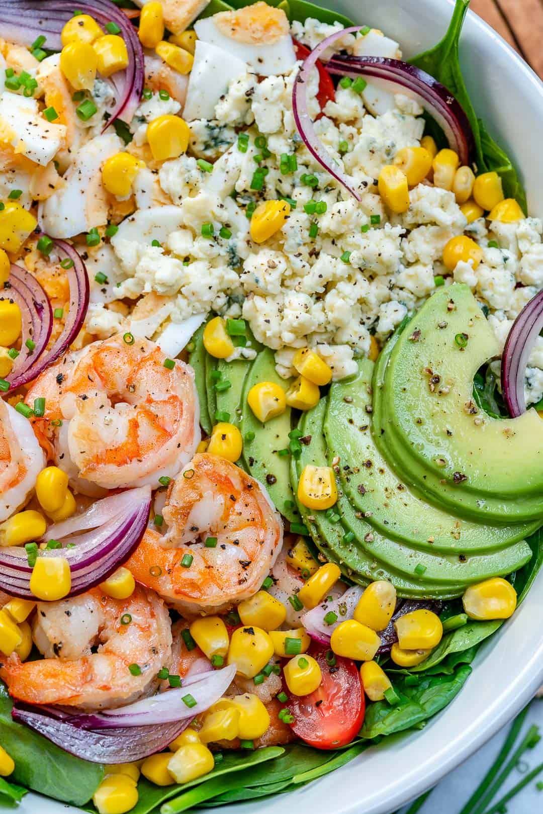 easy shrimp avocado salad recipe in bowl with blue cheese and veggies