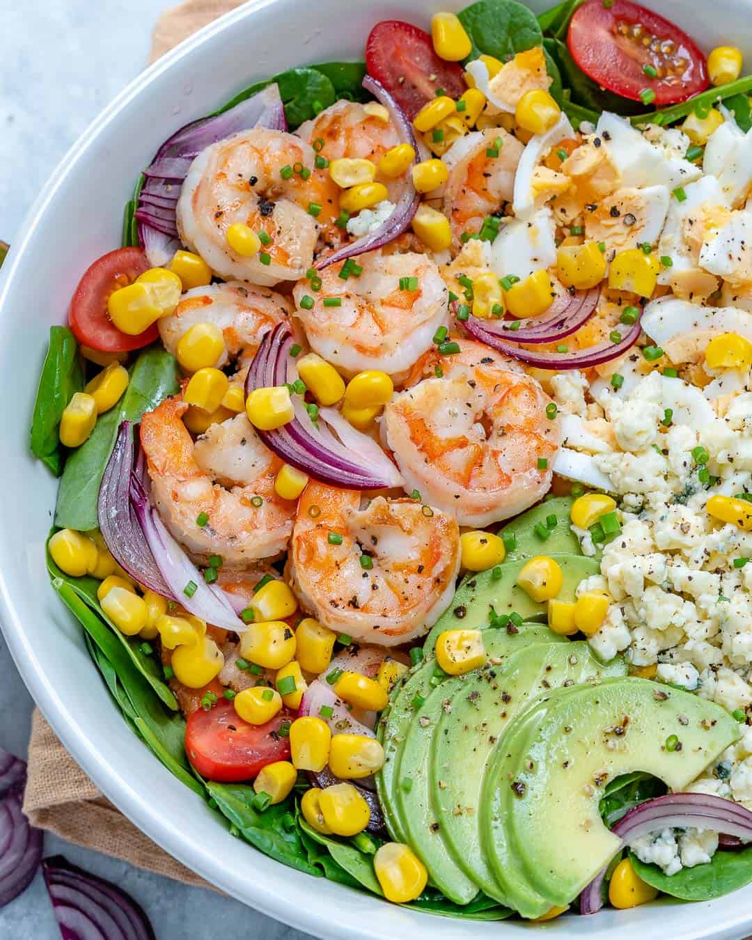 Spicy shrimp tomato avocado salad in bowl