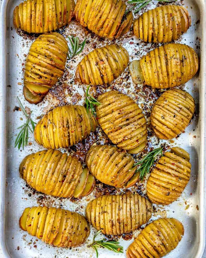 top view of baked Garlic butter Hasselback potatoes on a sheet pan 
