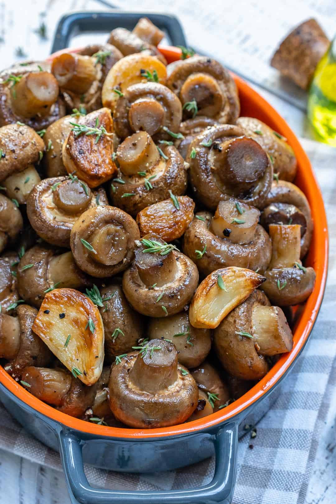 garlic roasted mushrooms with thyme in orange bowl