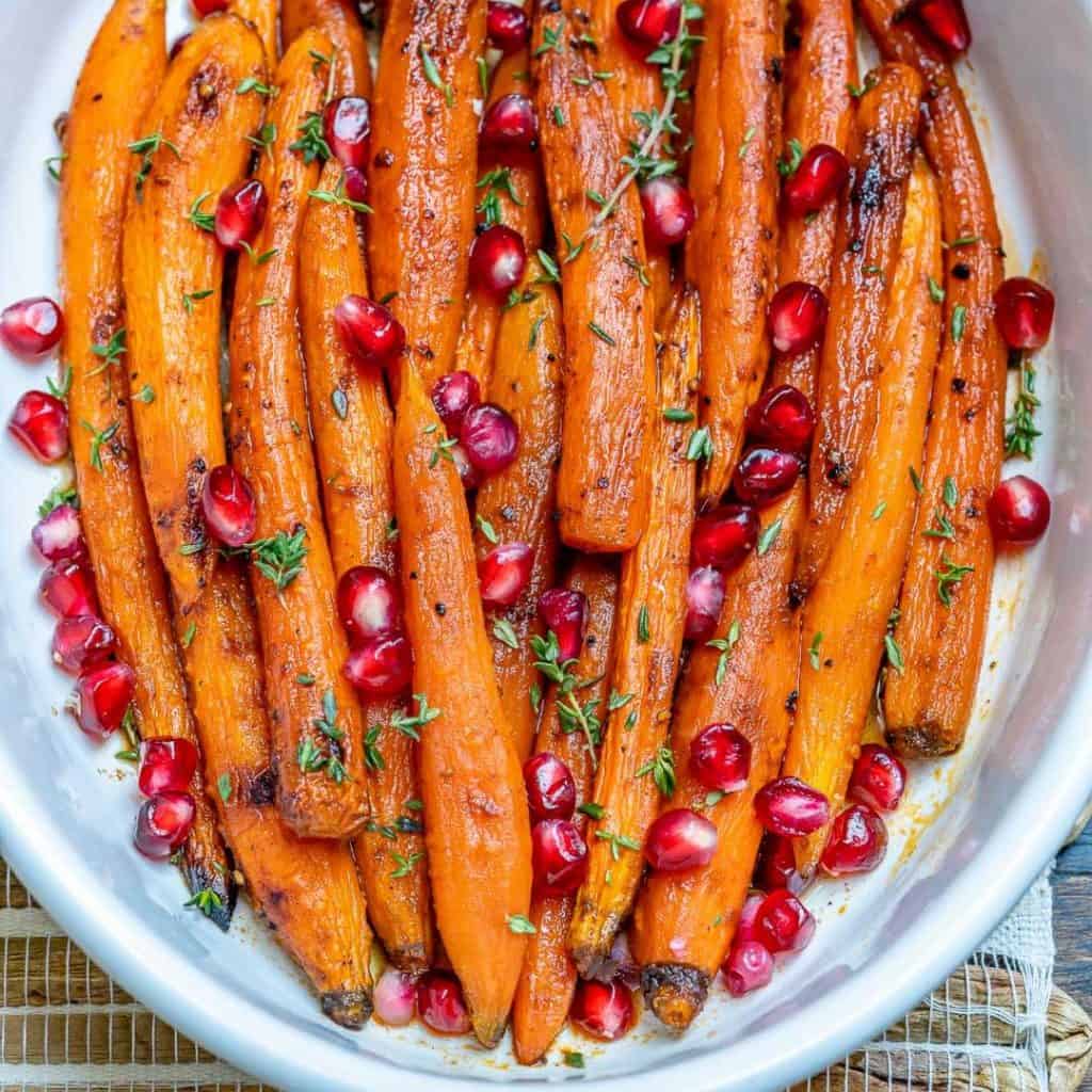 top view of roasted carrots on a white dish 