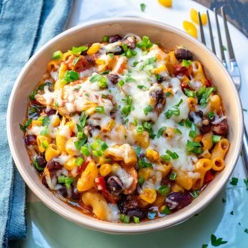 side shot of a bowl of chili mac recipe with fork on the right side