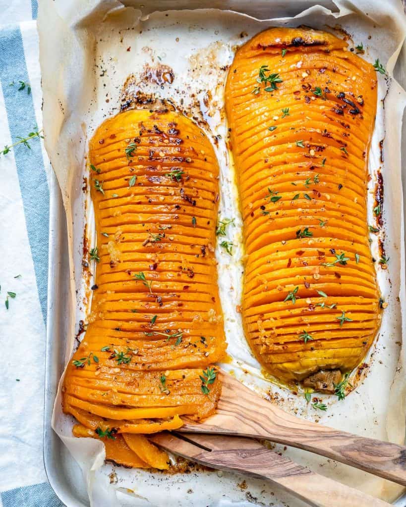 top view of two Hasselback butternut squash on a baking pan