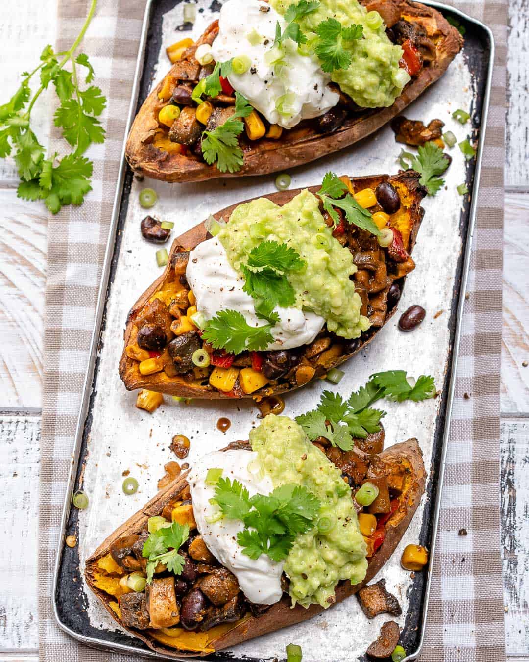 stuffed sweet potatoes with avocado, sour cream, and cilantro 