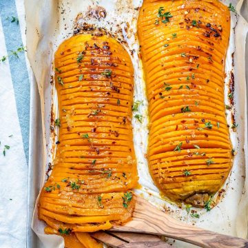 top view of two Hasselback butternut squash on a baking pan