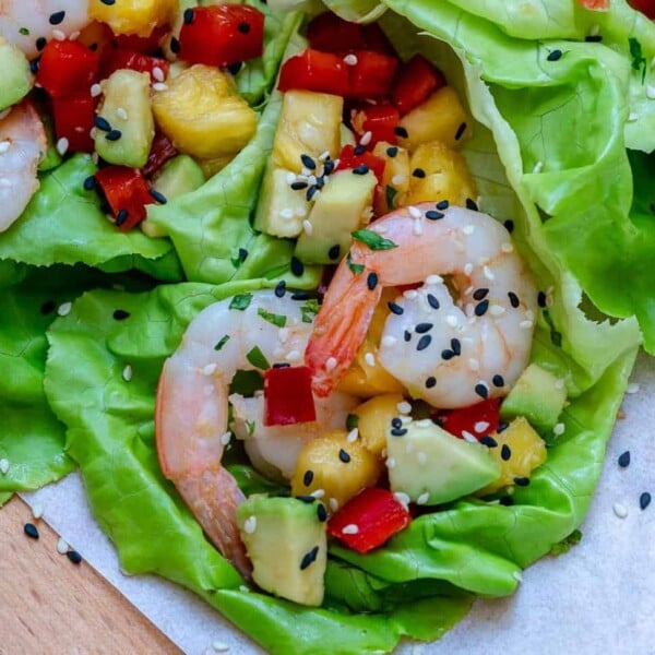 A lettuce wrap filled with shrimp and pineapple filling.