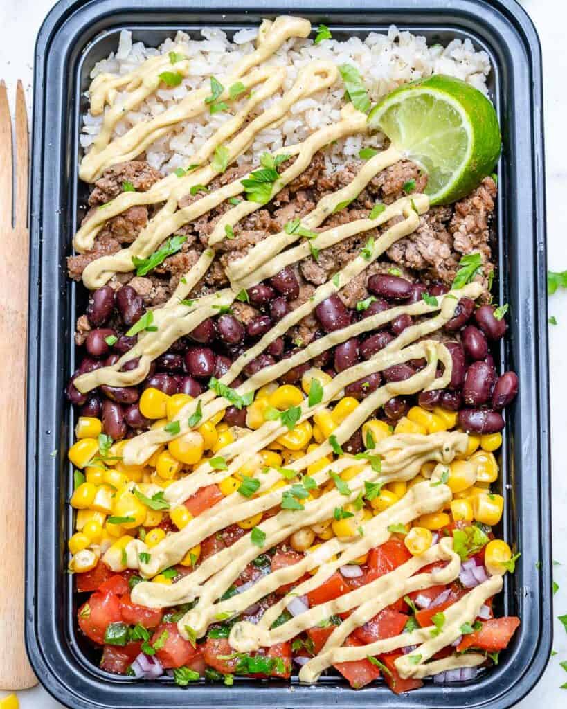 top view or meal prep bowl with beef burrito and rice 