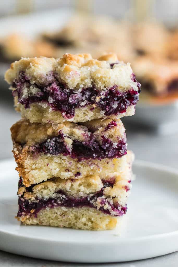 3 blueberry bars stack on a plate 