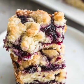 side view of breakfast blueberry bars stacked on a plate