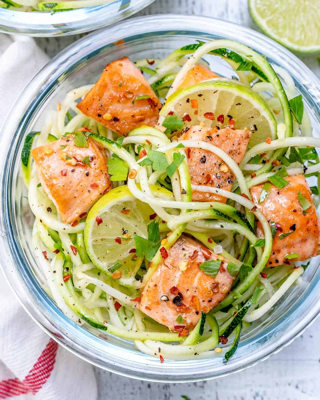 salmon and zoodles with lemon in a container.