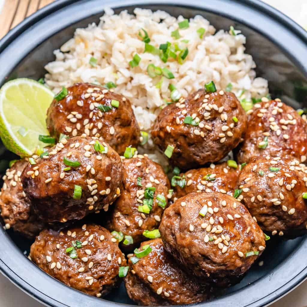 side shot Honey sriracha meatballs in a bowl with rice