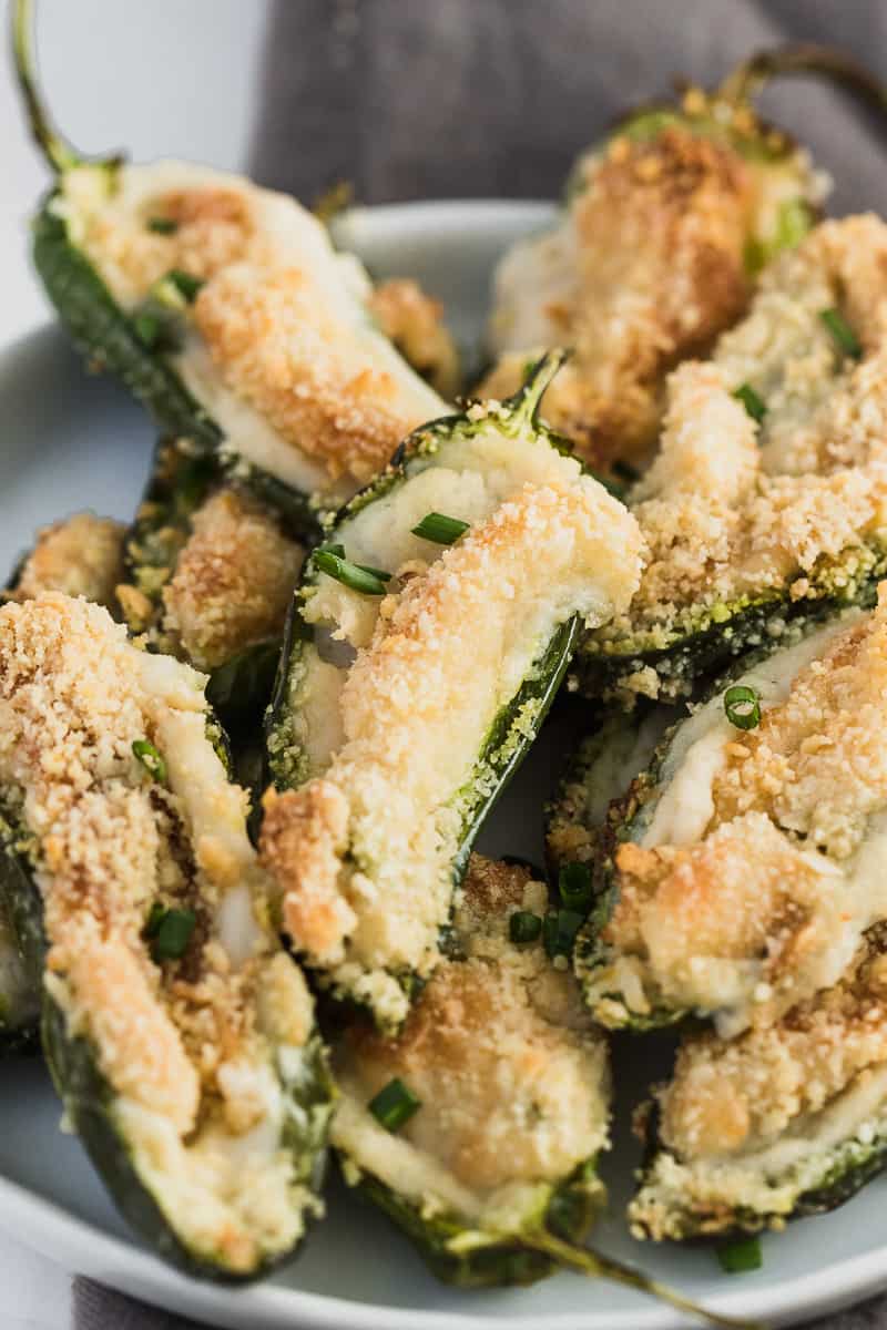 jalapeno poppers that are breaded and cooked on a plate.