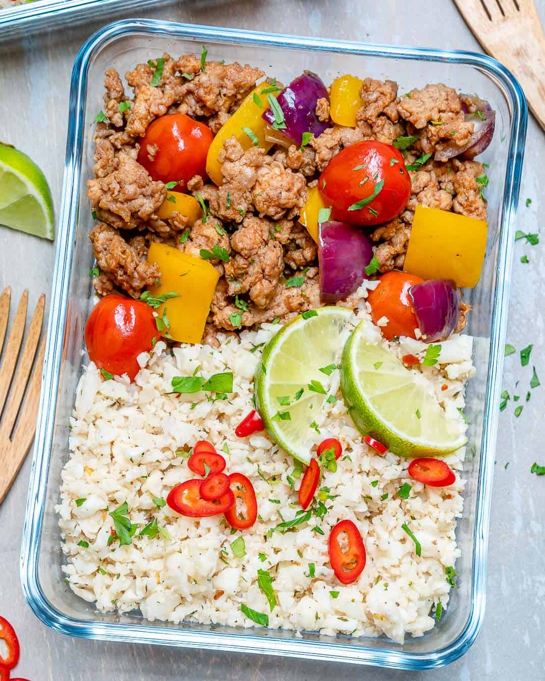 ground turkey and cauliflower rice recipe in glass container with veggies 