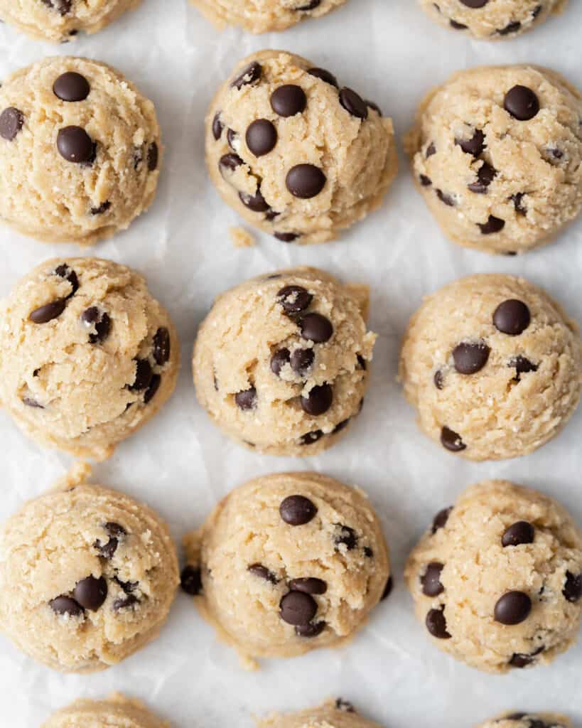 top view of scoops of edible cookie dough on a sheet pan