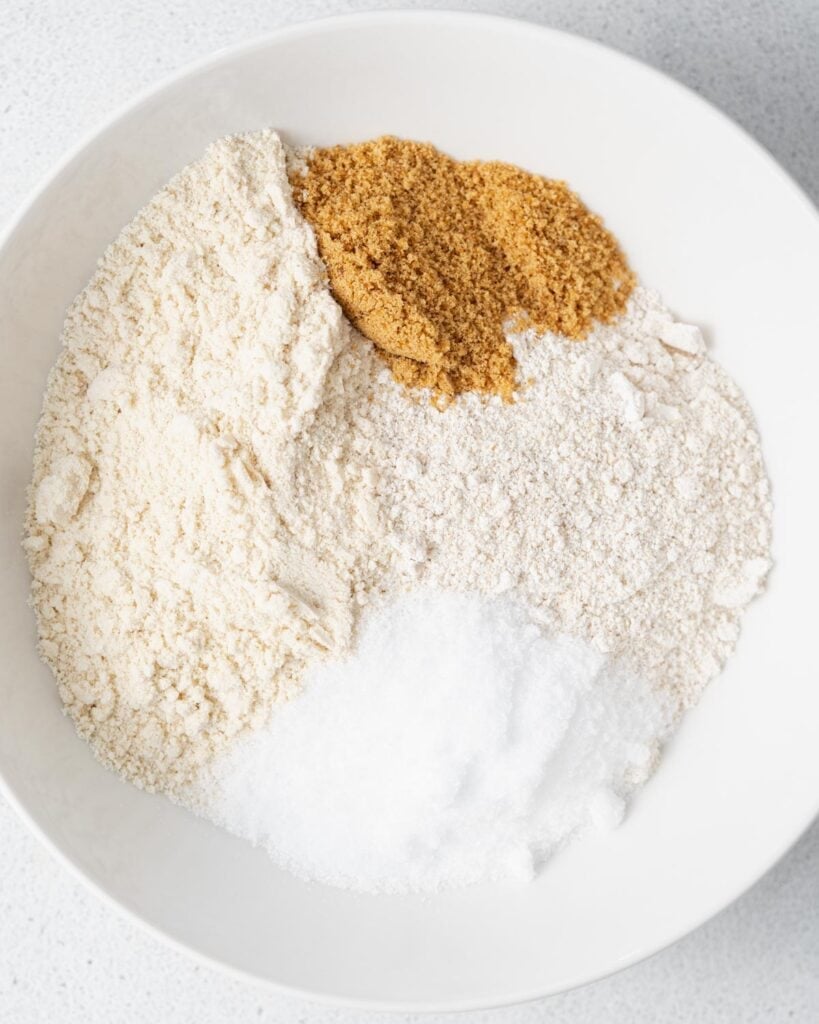 oat flour, coconut flour, almond flour, sweetener added to a bowl